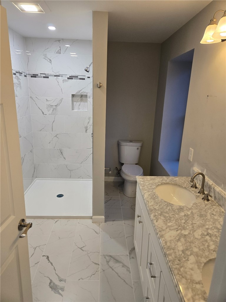 184 Avenue C, Unit S6 Woonsocket, RI 02895 - Photo 10 of 15 Primary bathroom featuring a double-sink vanity and a walk-in shower.