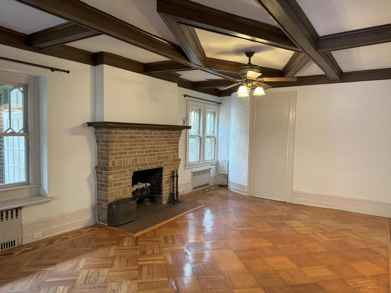 2024 Glenwood Road Brooklyn, NY 11210 - Photo 2 of 13 a view of an empty room with a fireplace and a window