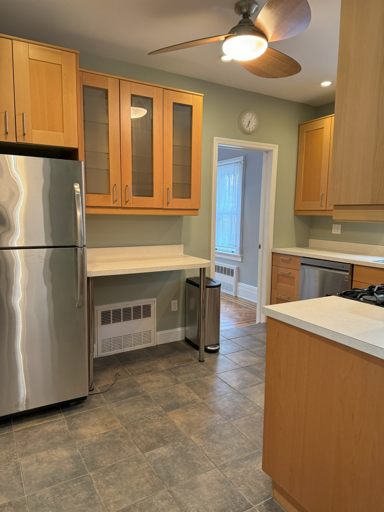 2024 Glenwood Road Brooklyn, NY 11210 - Photo 6 of 13 a kitchen with stainless steel appliances granite countertop a refrigerator a stove and a sink with cabinets