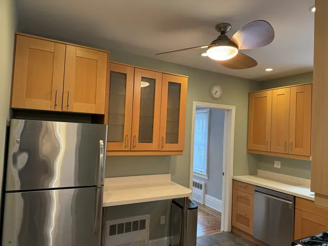 a kitchen with stainless steel appliances granite countertop a refrigerator a sink dishwasher and a stove