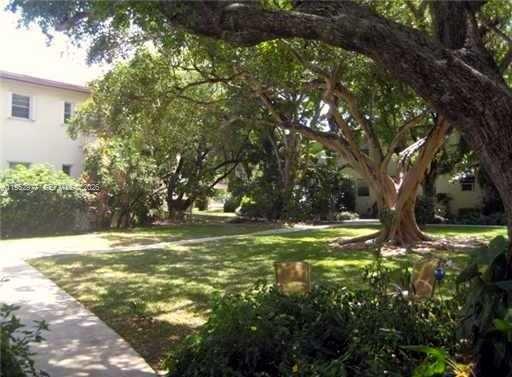 7840 Southwest 55th Avenue, Unit 22A Miami, FL 33143 - Photo 15 of 16 a view of a yard with a tree