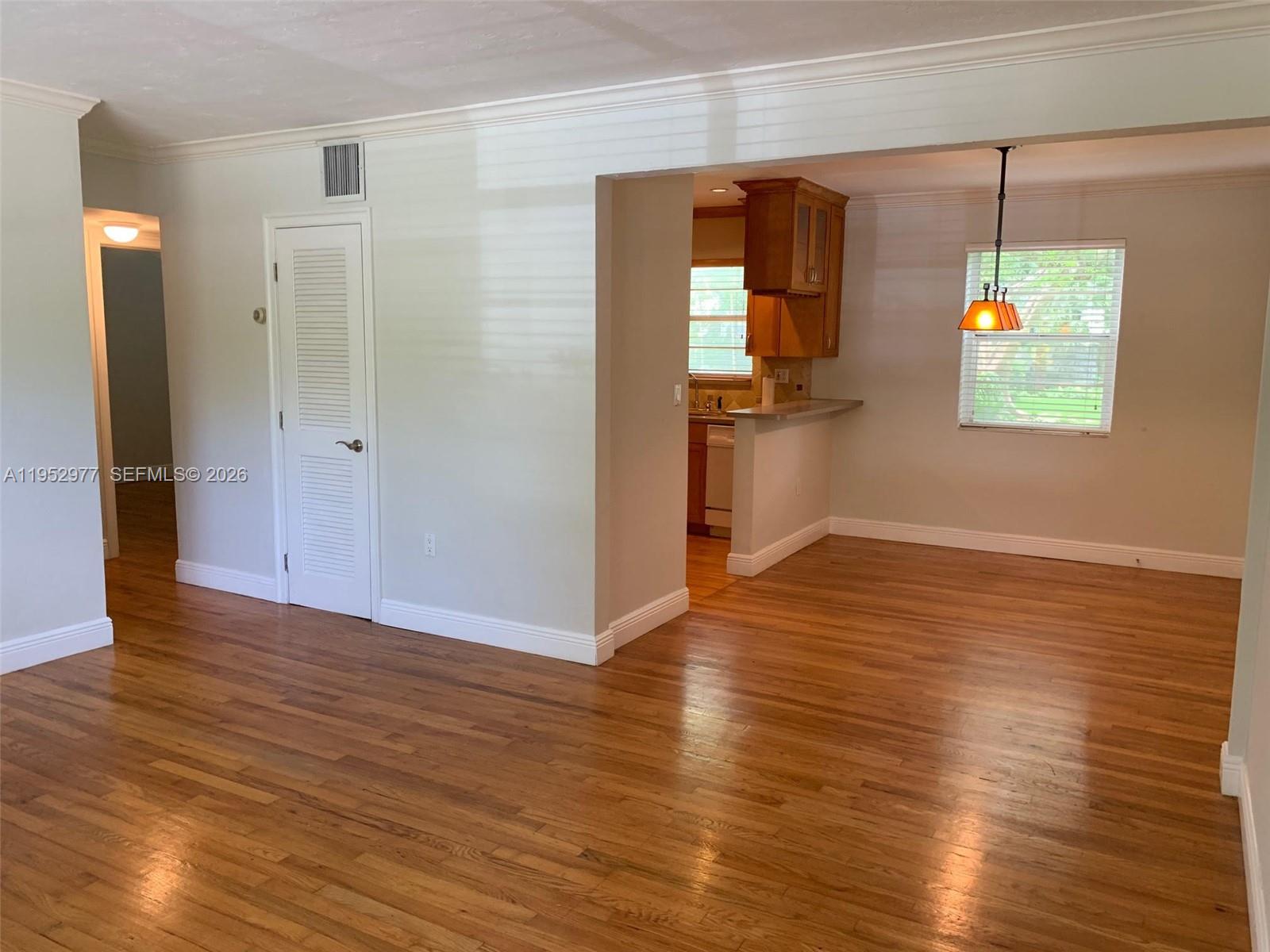 7840 Southwest 55th Avenue, Unit 22A Miami, FL 33143 - Photo 4 of 16 an empty room with wooden floor and windows