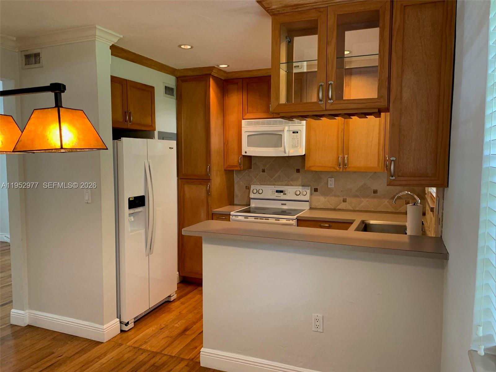 7840 Southwest 55th Avenue, Unit 22A Miami, FL 33143 - Photo 6 of 16 a kitchen with stainless steel appliances granite countertop a refrigerator a stove and a sink