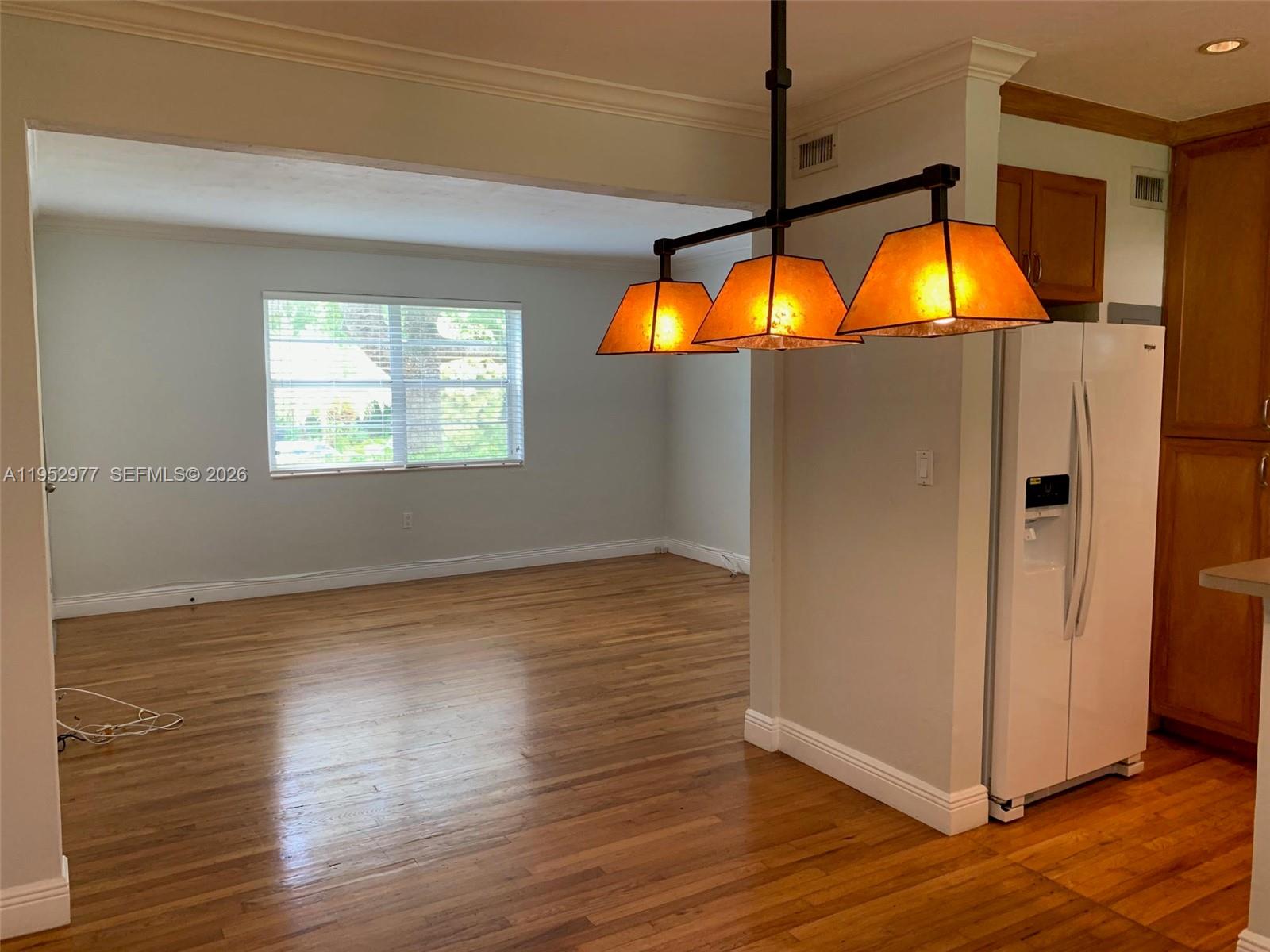 7840 Southwest 55th Avenue, Unit 22A Miami, FL 33143 - Photo 7 of 16 a view of a living room with a flat screen tv and wooden floor