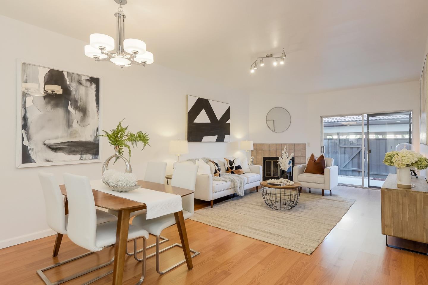 1400 Bowe Avenue, Unit 302 Santa Clara, CA 95051 - Photo 2 of 16 a living room with fireplace chandelier and wooden floor