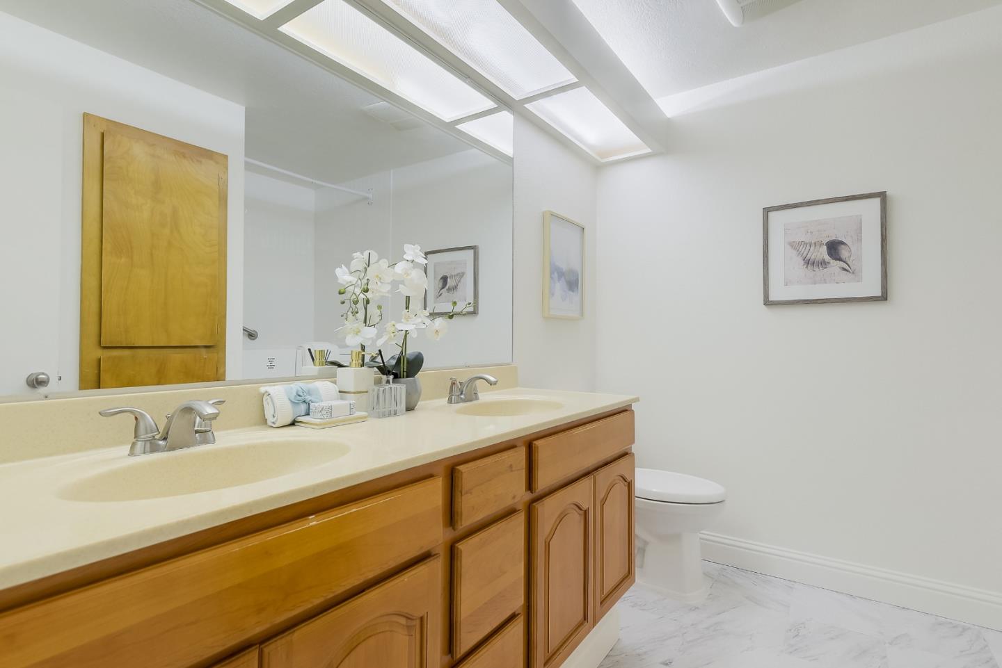 1400 Bowe Avenue, Unit 302 Santa Clara, CA 95051 - Photo 9 of 16 a bathroom with a toilet sink and mirror