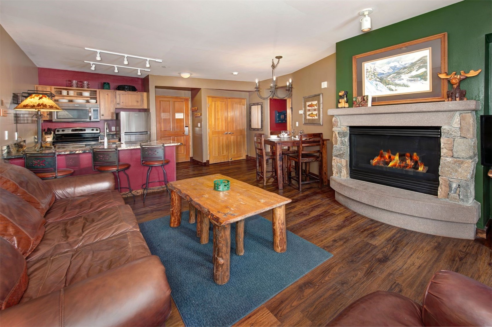 129 River Run Road, Unit 8040 Keystone, CO 80435 - Photo 6 of 50 Living area featuring dark wood-style flooring, a stone fireplace, and a chandelier