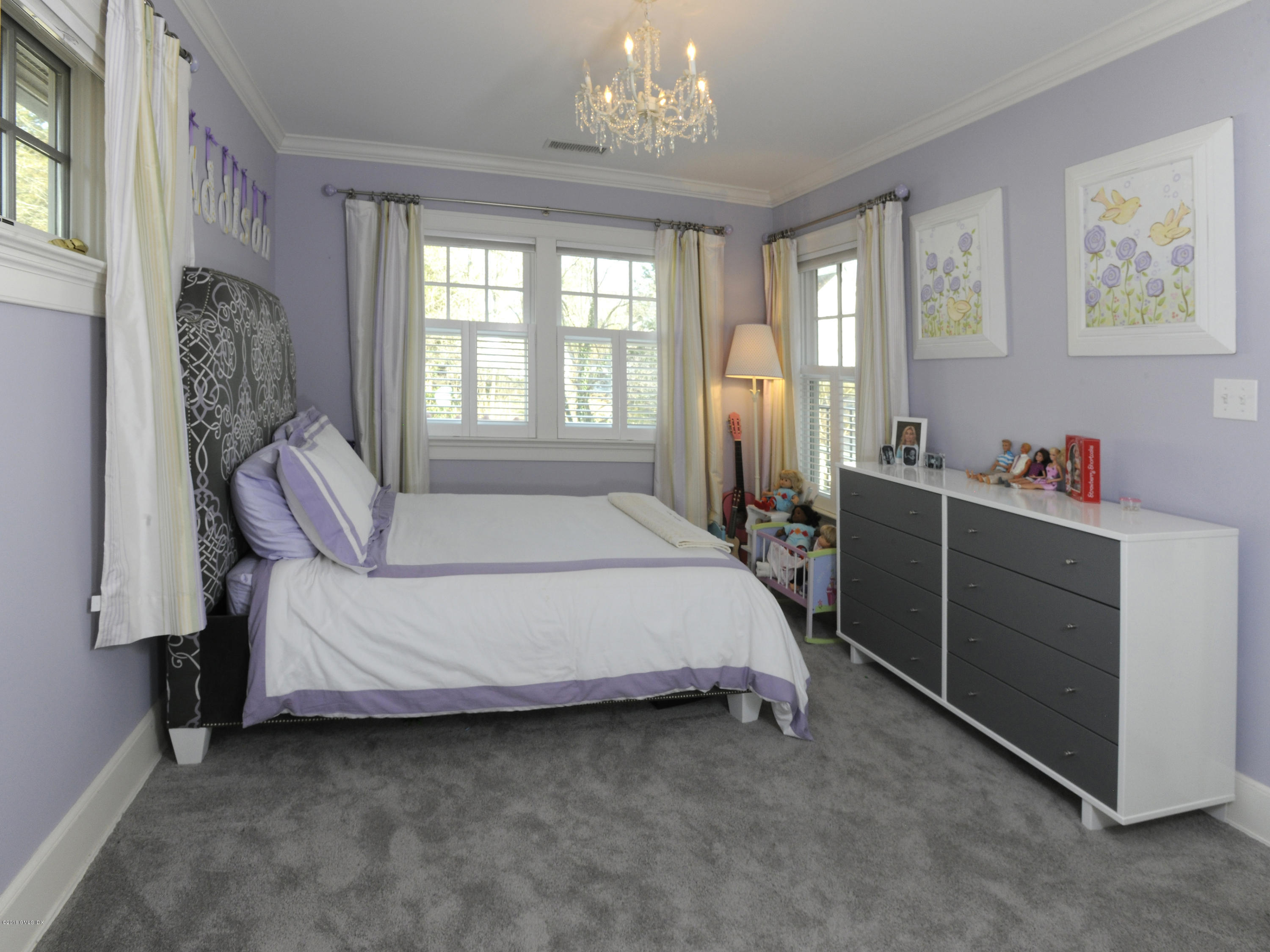 63 Indian Field Road Greenwich, CT 06830 - Photo 21 of 37 a bed room with a bed and a window