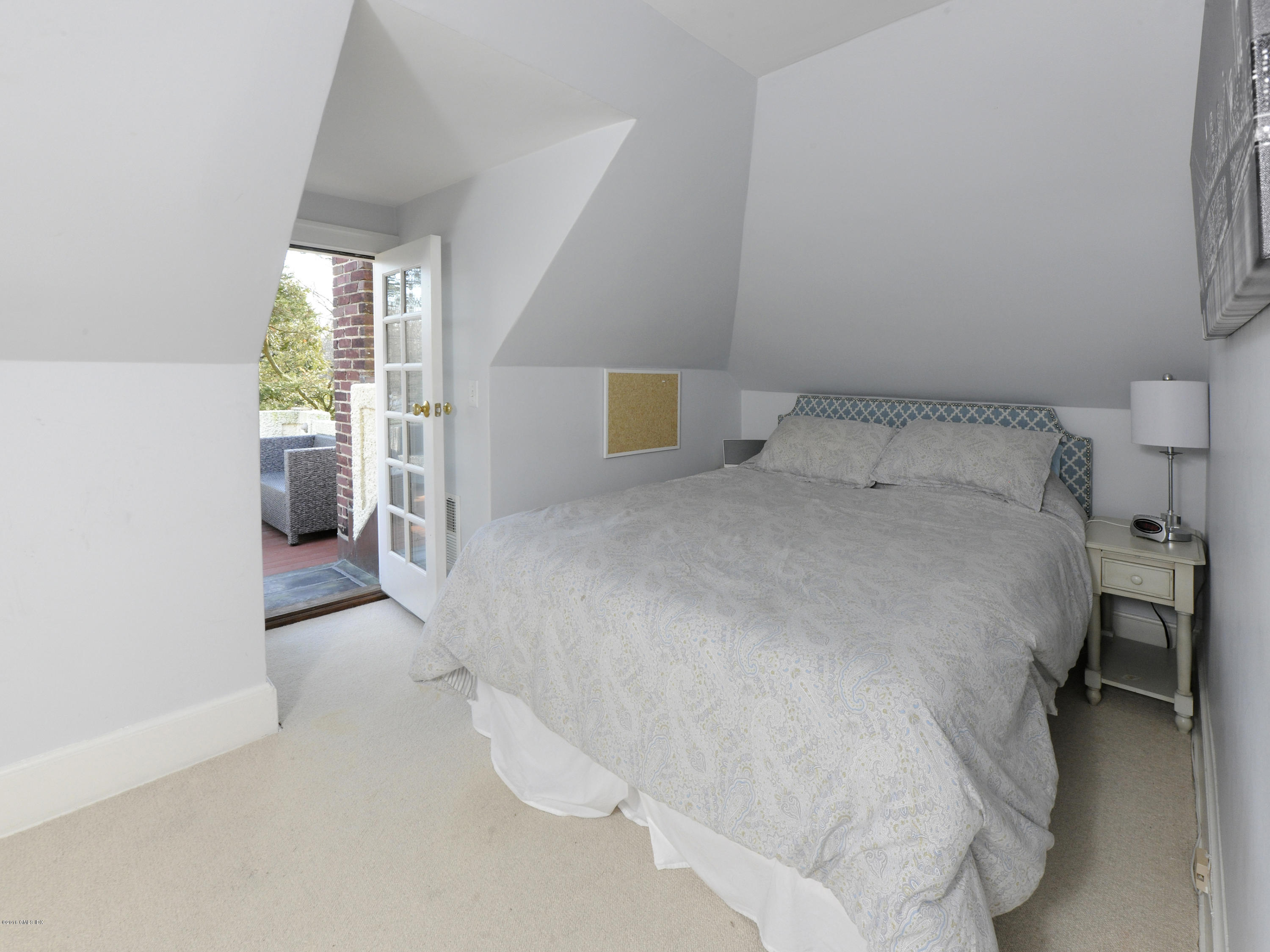 63 Indian Field Road Greenwich, CT 06830 - Photo 26 of 37 a bedroom with a bed and a window