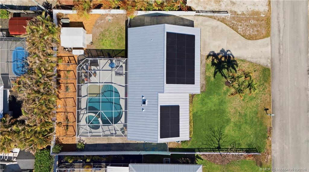 5605 Southeast Matousek Street Stuart, FL 34997 - Photo 2 of 8 an aerial view of a house with a yard and balcony