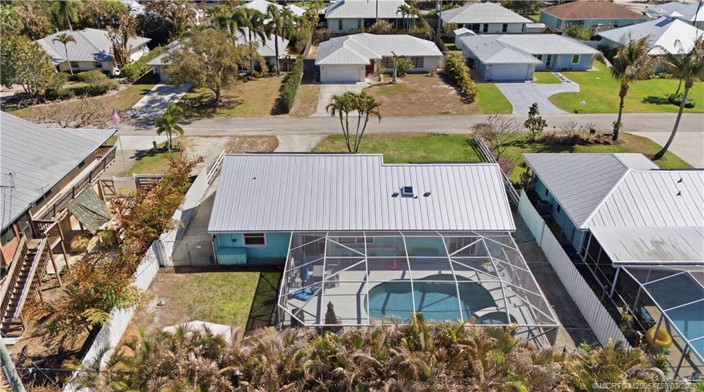 5605 Southeast Matousek Street Stuart, FL 34997 - Photo 4 of 8 an aerial view of residential houses with outdoor space