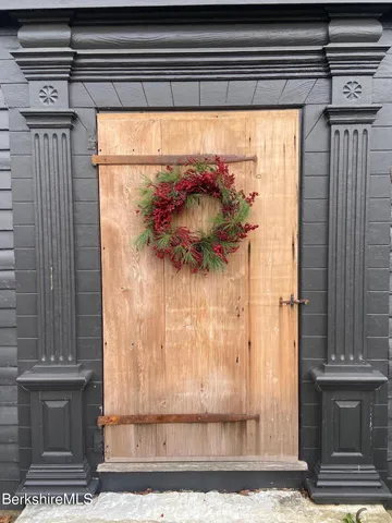 a view of a door of the house and a window