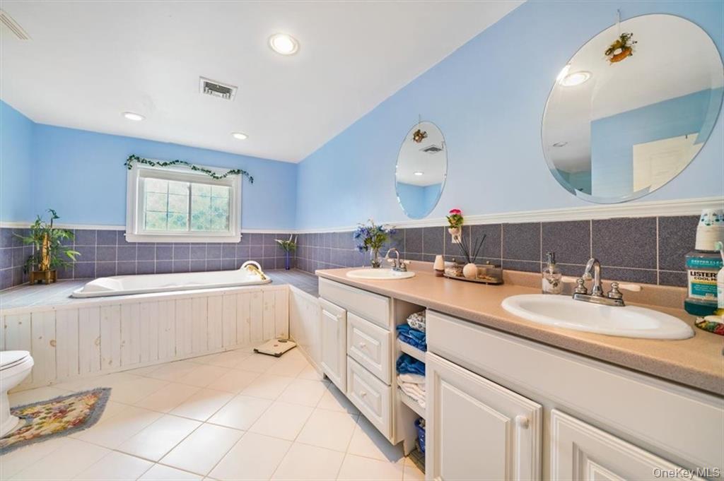 2 Bruyn Avenue Pine Bush, NY 12566 - Photo 5 of 9 a bathroom with a granite countertop sink mirror and bathtub
