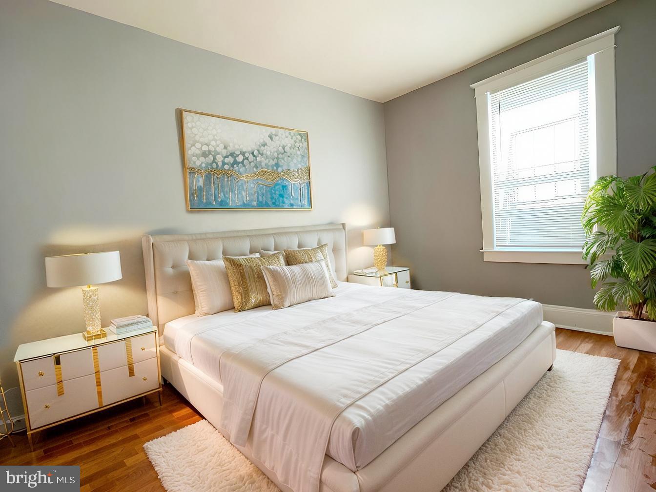 3609 Brooklyn Avenue Baltimore, MD 21225 - Photo 16 of 41 a bedroom with a large bed and a window