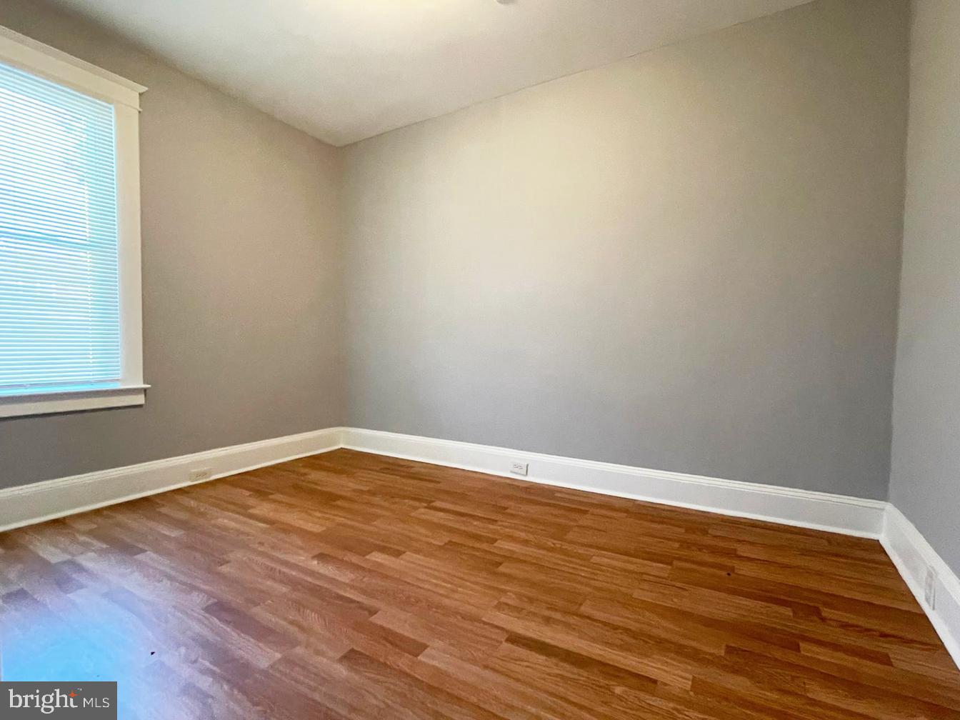 3609 Brooklyn Avenue Baltimore, MD 21225 - Photo 18 of 41 a view of an empty room with wooden floor and a window