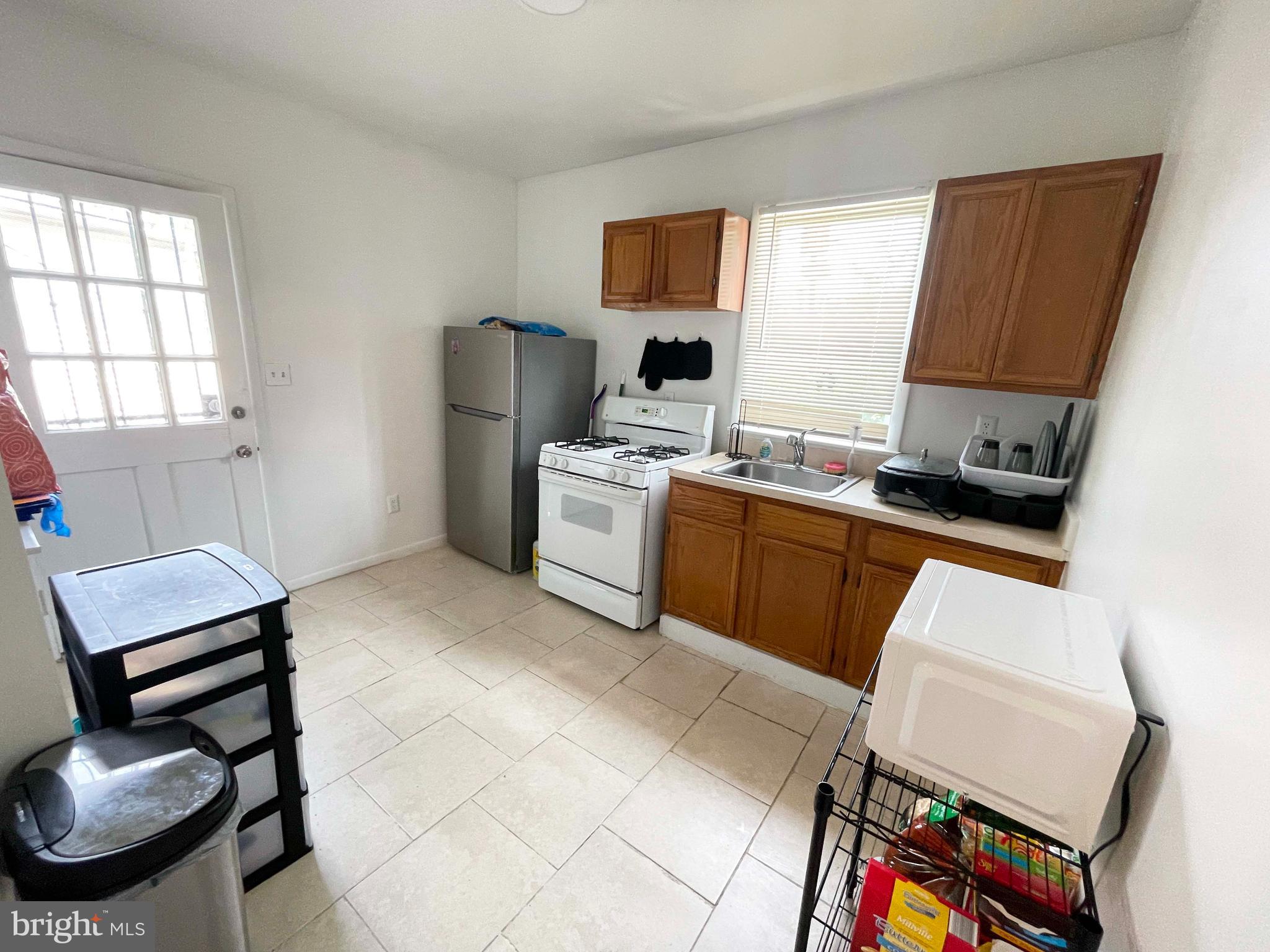 3609 Brooklyn Avenue Baltimore, MD 21225 - Photo 32 of 41 a kitchen with a sink appliances and cabinets
