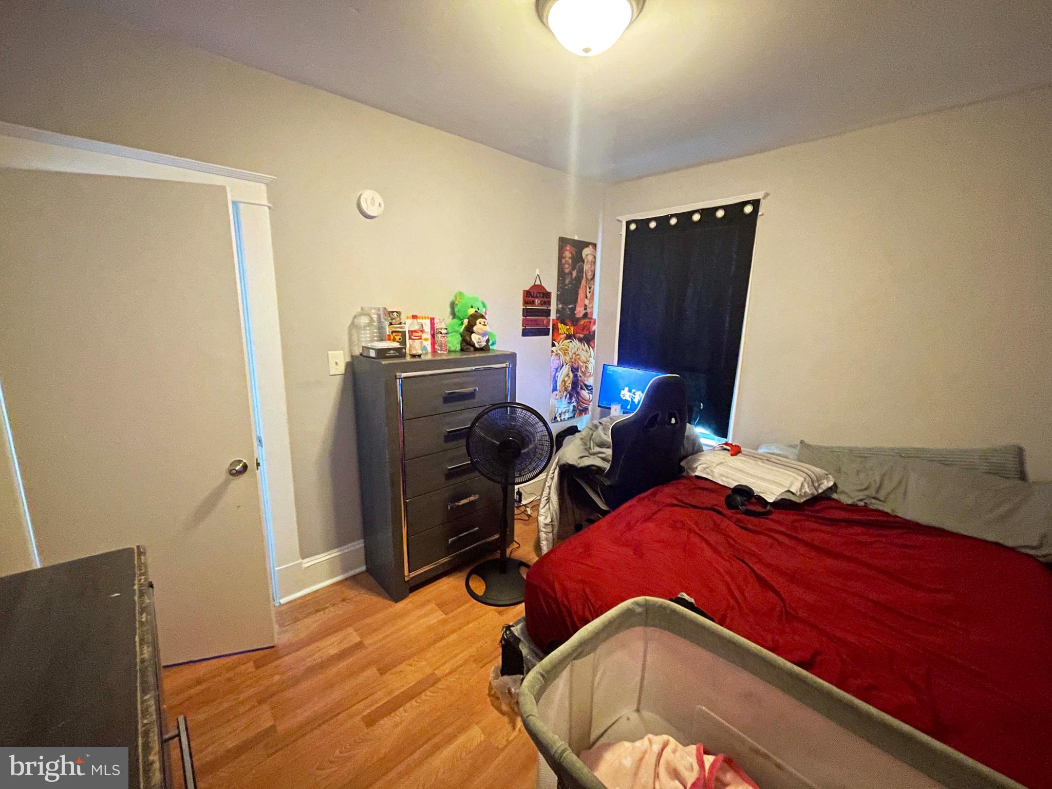 3609 Brooklyn Avenue Baltimore, MD 21225 - Photo 34 of 41 a bedroom with a bed and wooden floor
