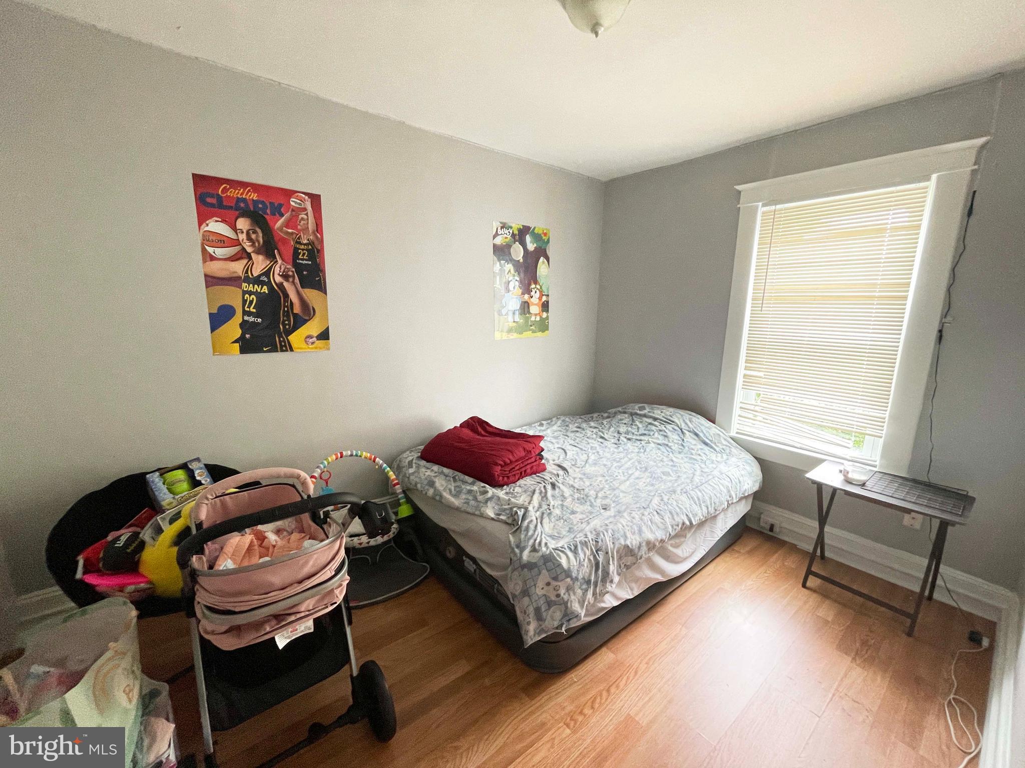 3609 Brooklyn Avenue Baltimore, MD 21225 - Photo 35 of 41 a bedroom with a bed and a chair