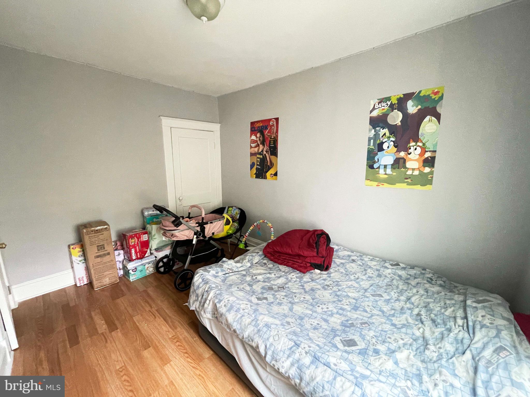 3609 Brooklyn Avenue Baltimore, MD 21225 - Photo 36 of 41 a bedroom with a bed and dresser