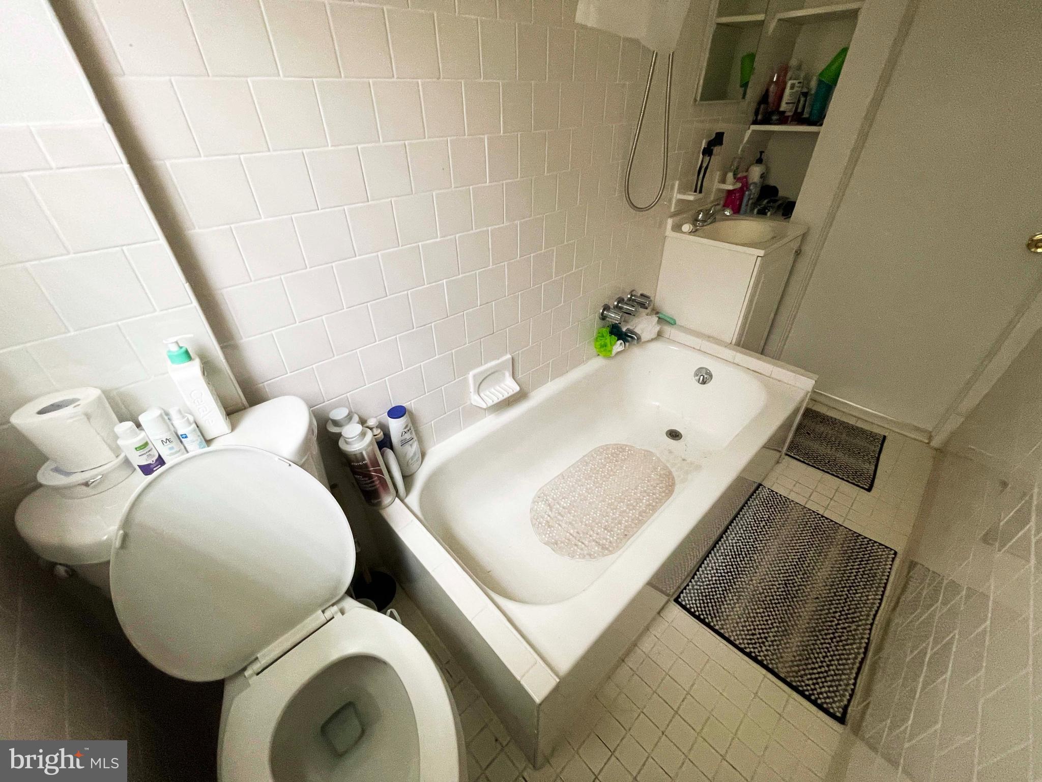 3609 Brooklyn Avenue Baltimore, MD 21225 - Photo 38 of 41 a bathroom with a sink and mirror with toilet
