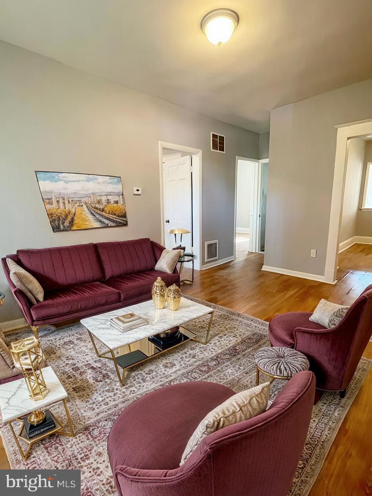 3609 Brooklyn Avenue Baltimore, MD 21225 - Photo 5 of 41 a living room with furniture and wooden floor