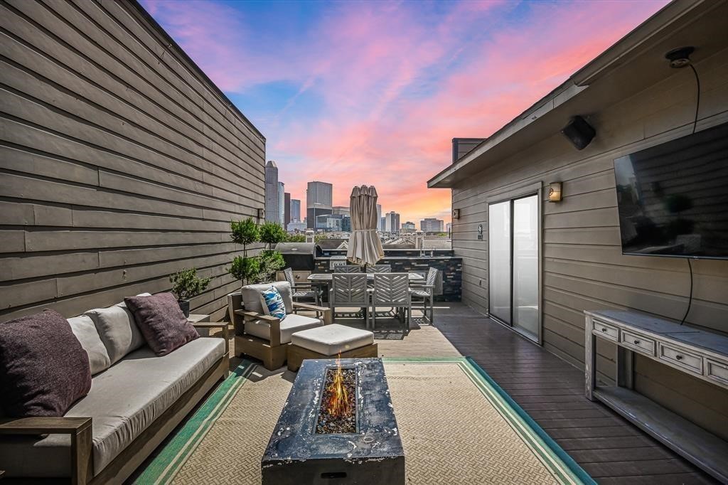 a terrace with outdoor seating and wooden floor
