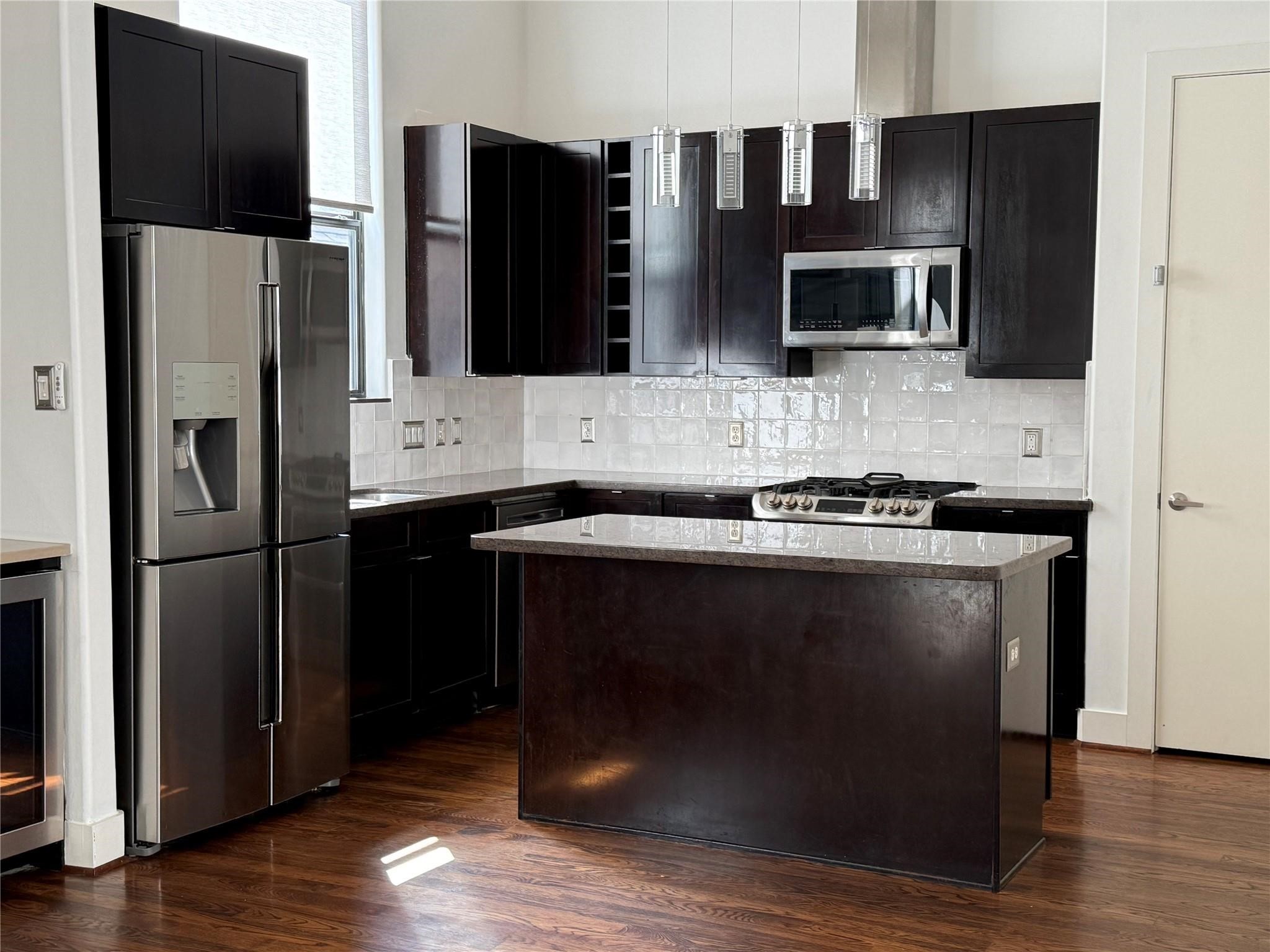 1608 West Webster Street, Unit B Houston, TX 77019 - Photo 5 of 9 a kitchen with a sink and stainless steel appliances