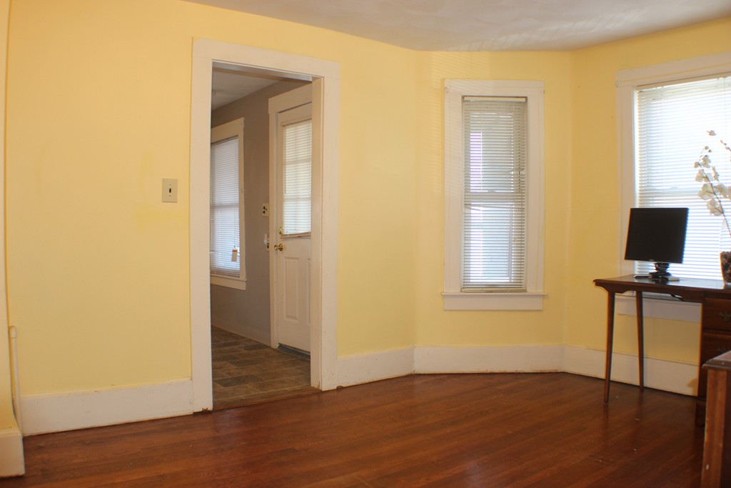 43 Farmland Road Lowell, MA 01850 - Photo 11 of 27 an empty room with wooden floor and windows