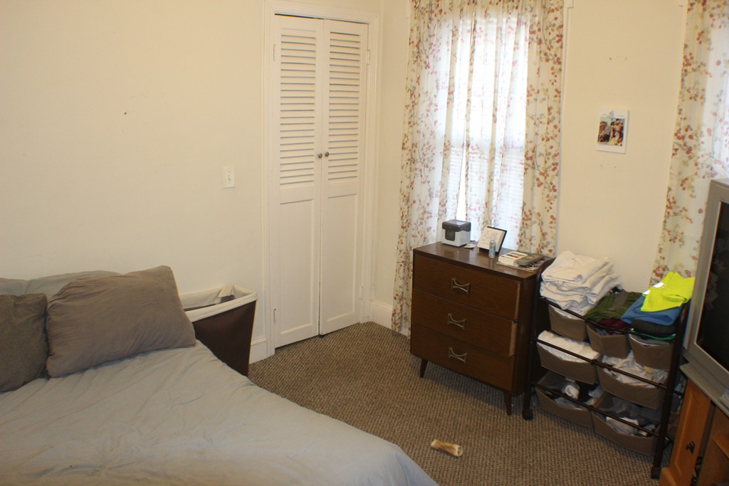 43 Farmland Road Lowell, MA 01850 - Photo 19 of 27 a bedroom with a bed and a window