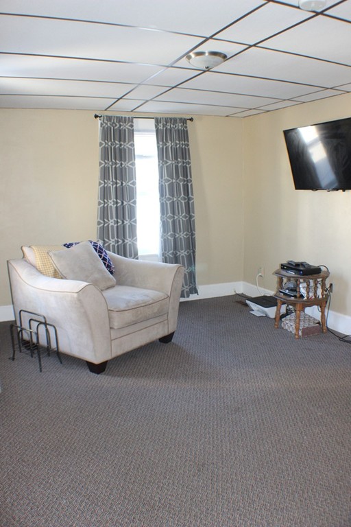 43 Farmland Road Lowell, MA 01850 - Photo 2 of 27 a bedroom with a bed and a chandelier