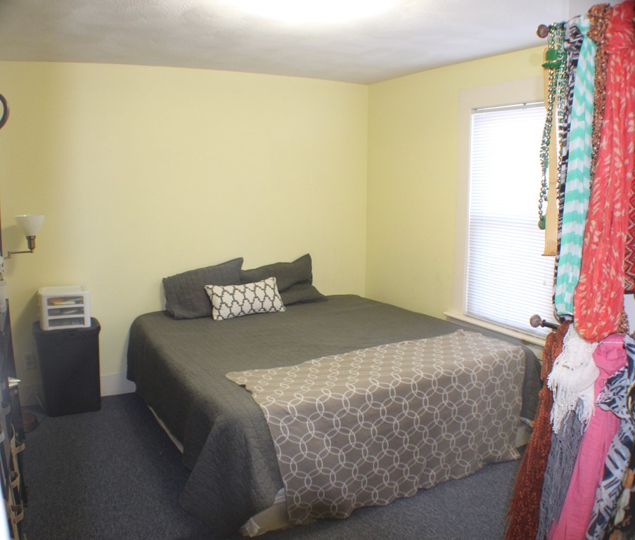 43 Farmland Road Lowell, MA 01850 - Photo 3 of 27 a bedroom with a bed and a couch