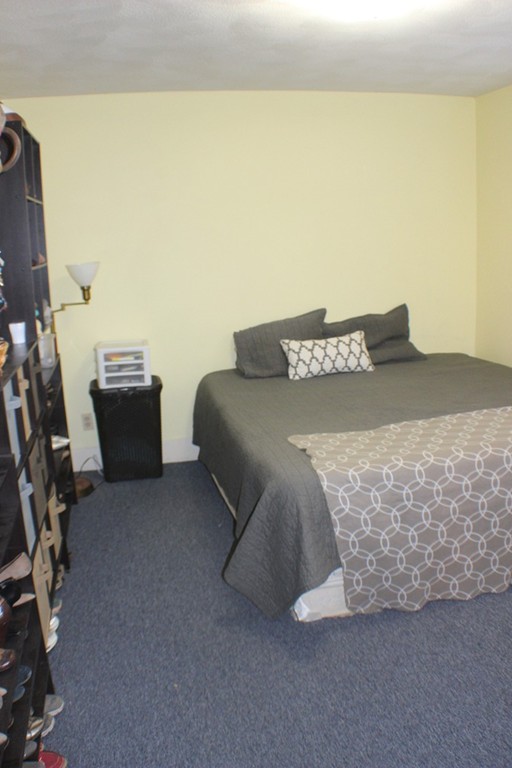 43 Farmland Road Lowell, MA 01850 - Photo 4 of 27 a bedroom with a bed and furniture