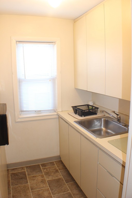 43 Farmland Road Lowell, MA 01850 - Photo 5 of 27 a kitchen with a sink cabinets and a window