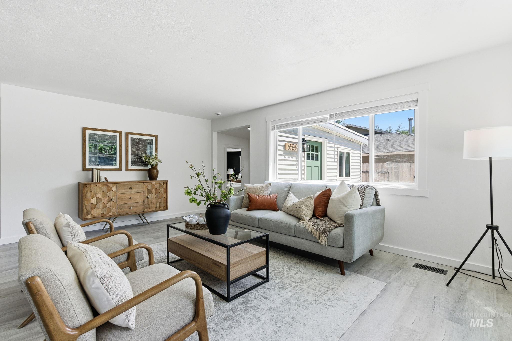 2224 Rachel Circle Boise, ID 83706 - Photo 13 of 50 Bright interior space featuring light wood-finish flooring, white wall finishes, and a large window