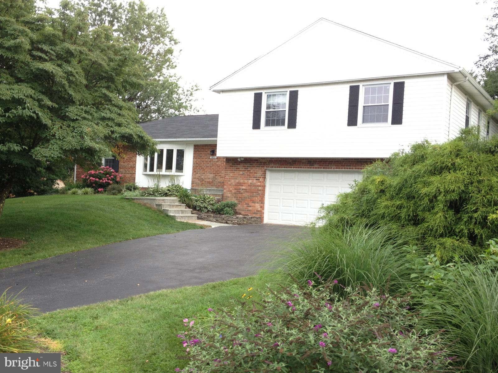 18808 Bloomfield Road Olney, MD 20832 - Photo 2 of 2 a front view of house with yard and green space