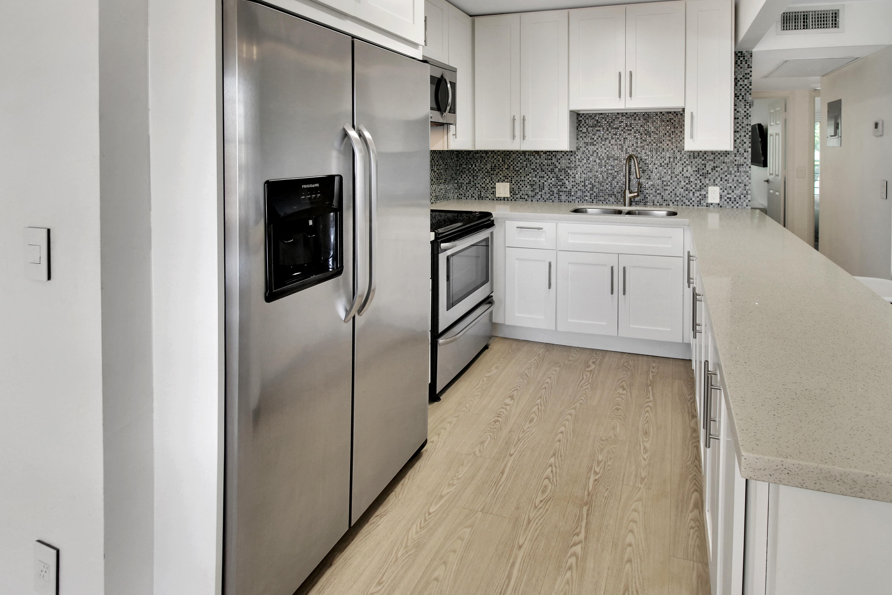 17 Fanshaw A Boca Raton, FL 33434 - Photo 5 of 11 a kitchen with stainless steel appliances granite countertop a refrigerator and a stove