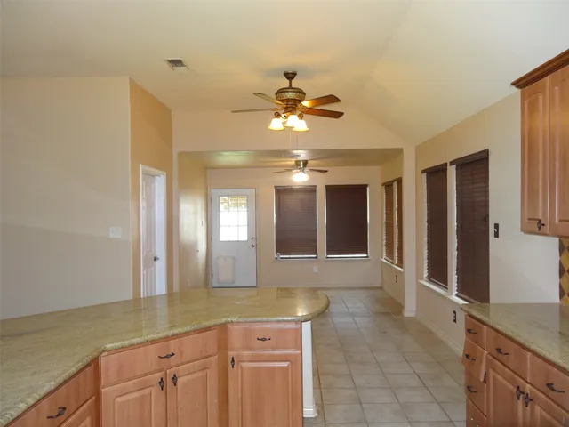 a bathroom with a granite countertop sink a large mirror and a shower
