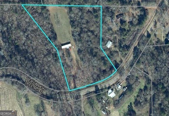 7911 Persimmon Tree Road Lula, GA 30554 - Photo 1 of 1 a view of a dry yard with large tree