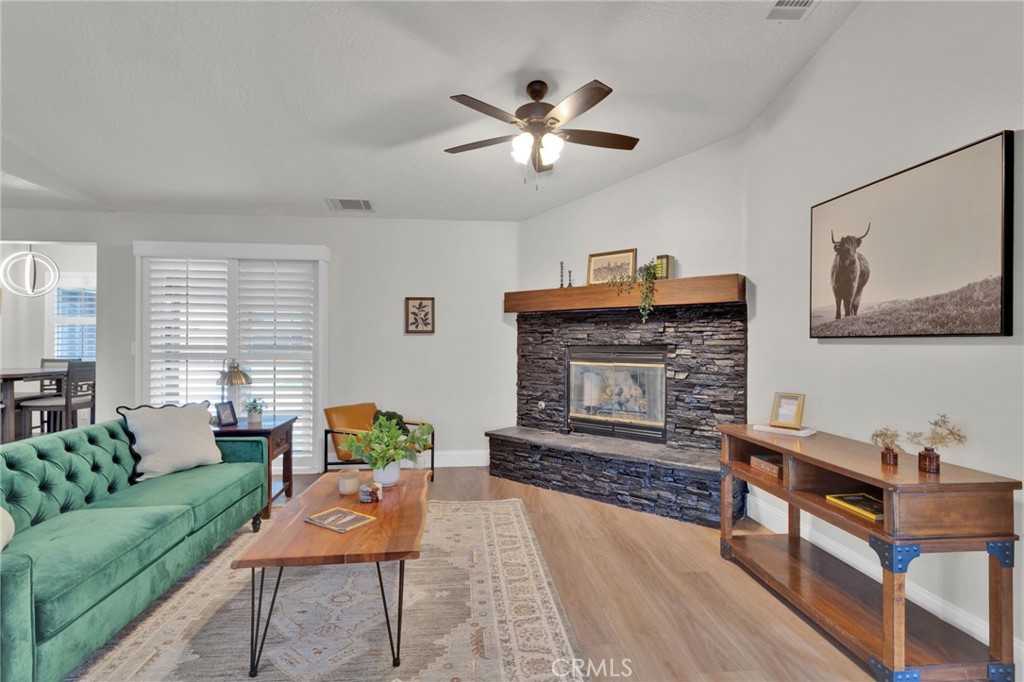 11410 Cibola Road Apple Valley, CA 92308 - Photo 11 of 45 a living room with furniture and a fireplace