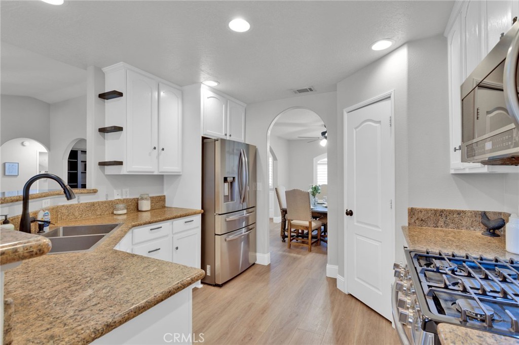 11410 Cibola Road Apple Valley, CA 92308 - Photo 13 of 45 a kitchen with stainless steel appliances granite countertop a sink stove and refrigerator