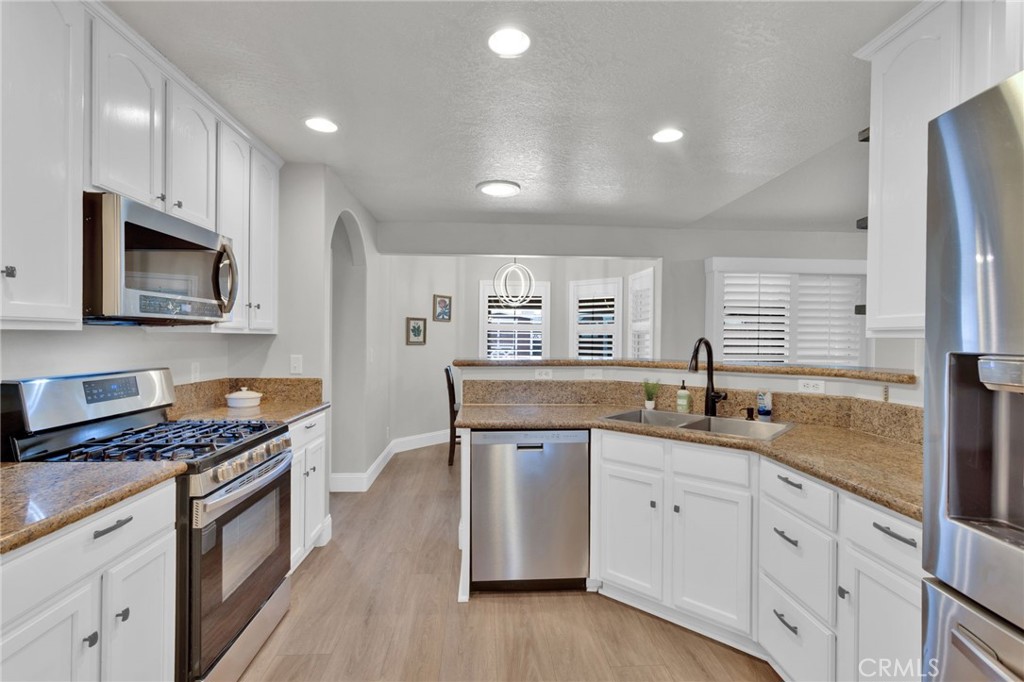 11410 Cibola Road Apple Valley, CA 92308 - Photo 14 of 45 a kitchen with granite countertop cabinets stainless steel appliances a sink and wooden floor