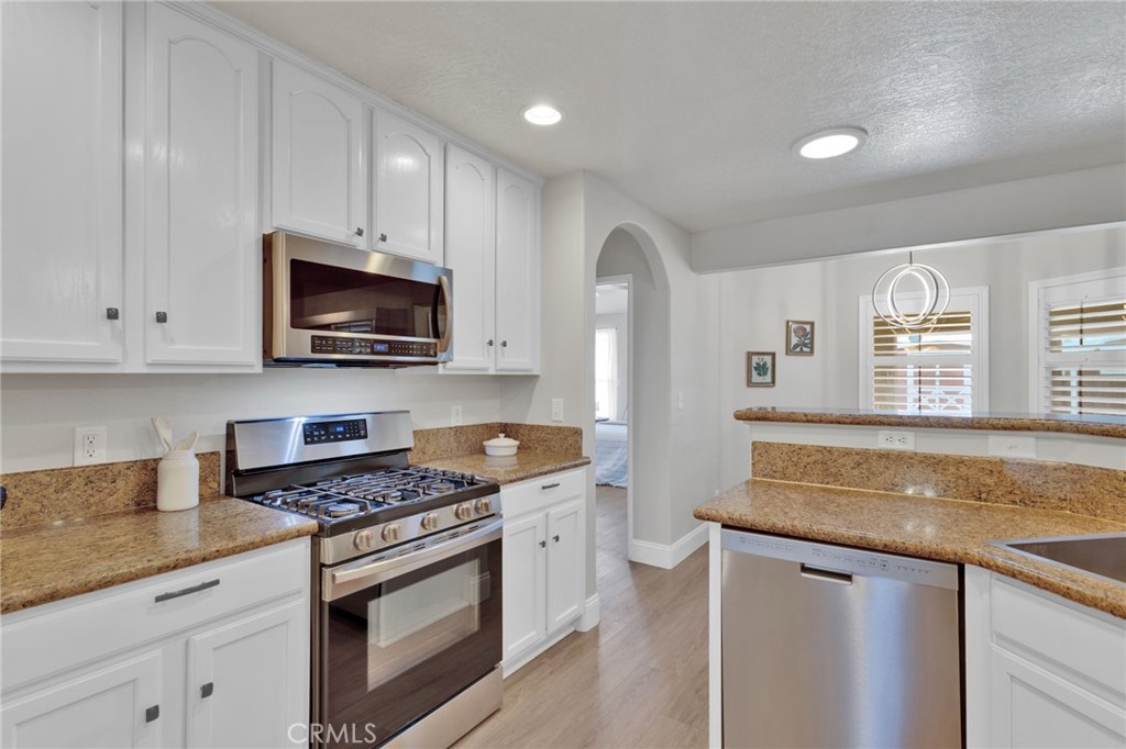 11410 Cibola Road Apple Valley, CA 92308 - Photo 15 of 45 a kitchen with granite countertop a sink cabinets stainless steel appliances and a window
