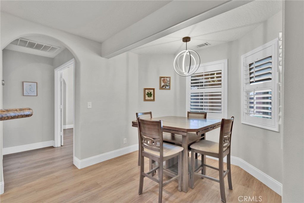 11410 Cibola Road Apple Valley, CA 92308 - Photo 17 of 45 a view of a dining room with furniture and wooden floor