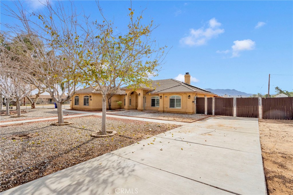 11410 Cibola Road Apple Valley, CA 92308 - Photo 2 of 45 a front view of a house with a yard