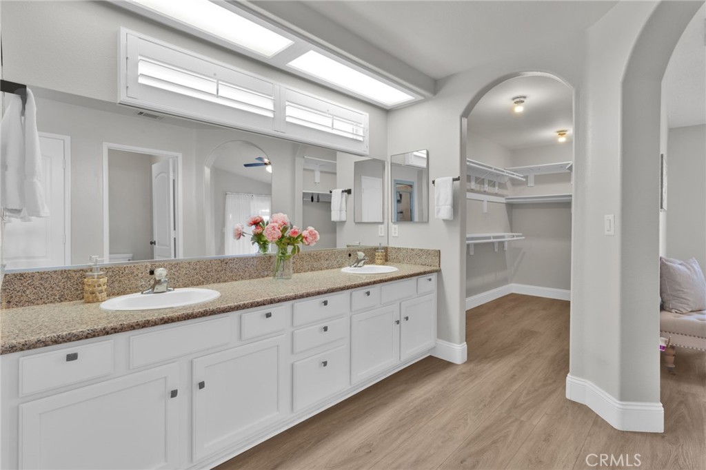 11410 Cibola Road Apple Valley, CA 92308 - Photo 21 of 45 a spacious bathroom with double sink and a large mirror
