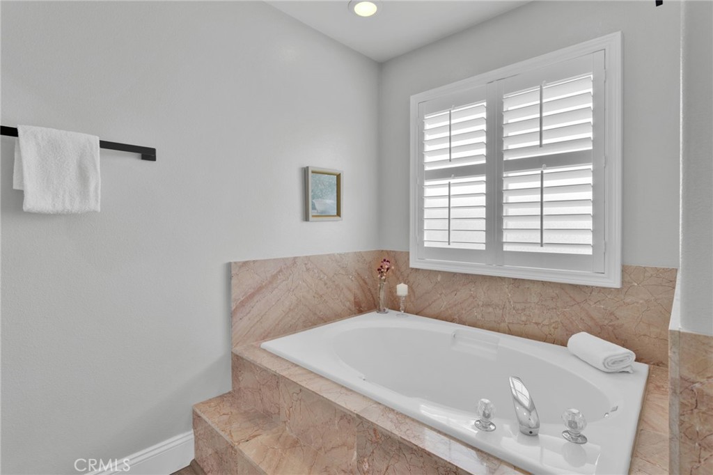 11410 Cibola Road Apple Valley, CA 92308 - Photo 22 of 45 a bath tub sitting in a bathroom next to a window