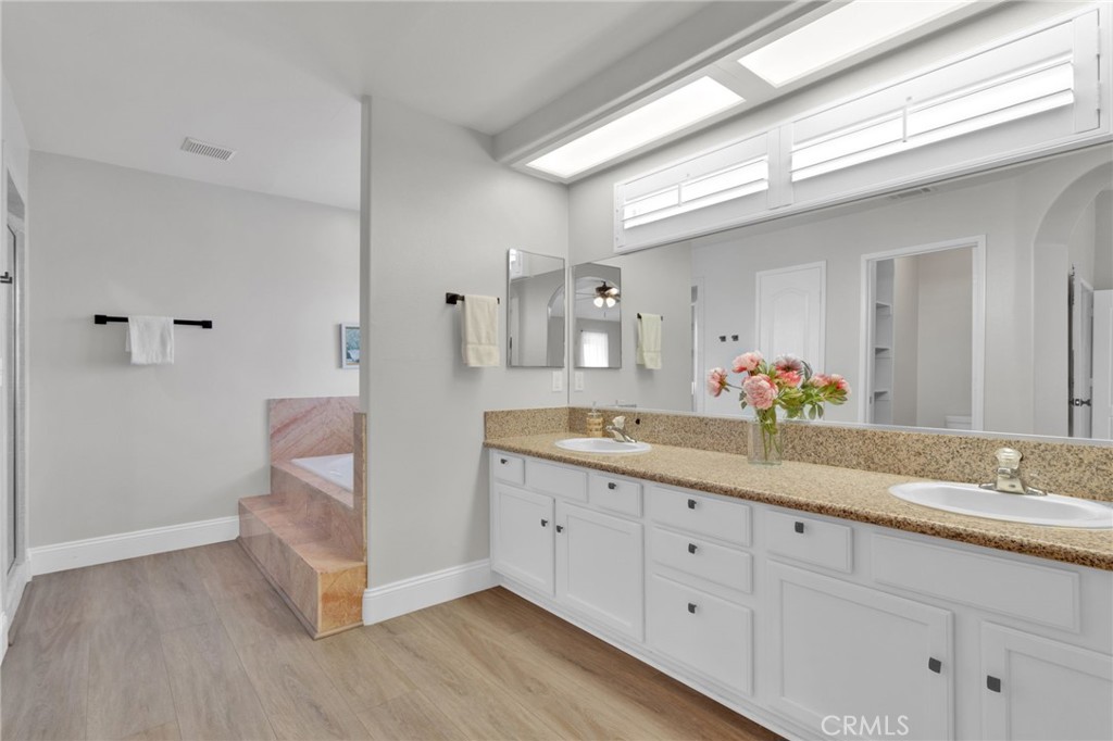 11410 Cibola Road Apple Valley, CA 92308 - Photo 24 of 45 a spacious bathroom with a double vanity sink and a mirror
