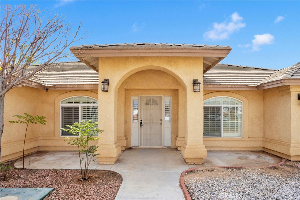 11410 Cibola Road Apple Valley, CA 92308 - Photo 3 of 45 a view of a house with potted plants