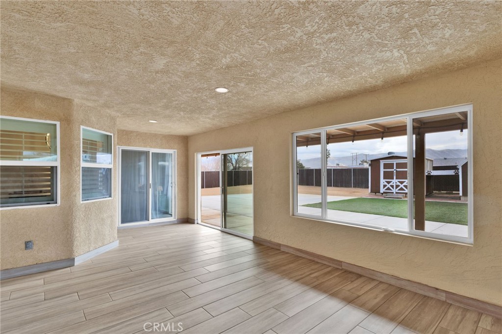 11410 Cibola Road Apple Valley, CA 92308 - Photo 32 of 45 a view of livingroom with furniture wooden floor and windows