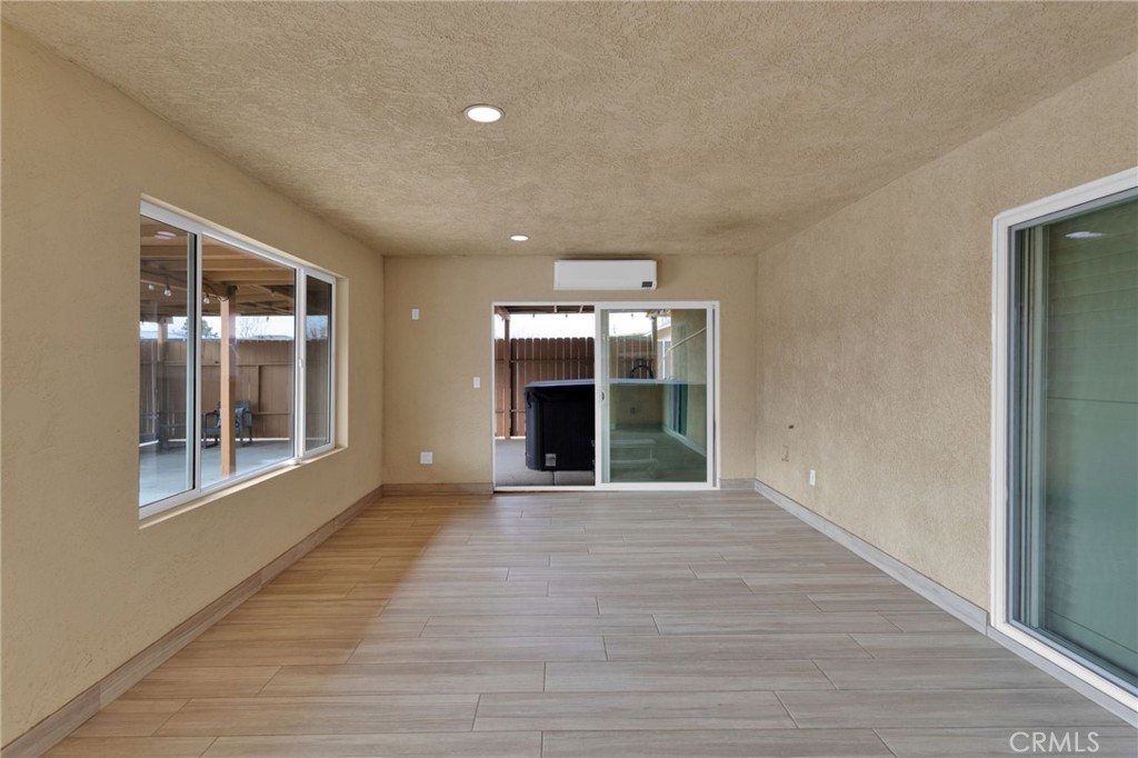 11410 Cibola Road Apple Valley, CA 92308 - Photo 33 of 45 a view of an empty room with wooden floor and a window